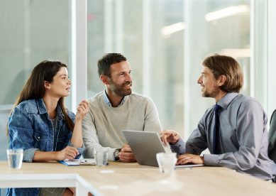 Image of young couple meeting with a businessman in the office