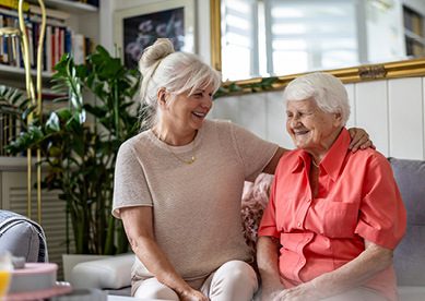 Image of mature woman sitting with her adult daughter
