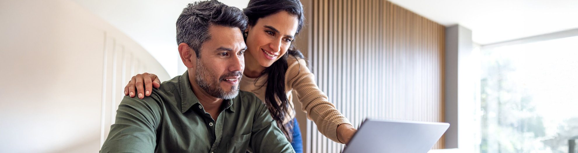 Image of older couple reviewing finances in kitchen