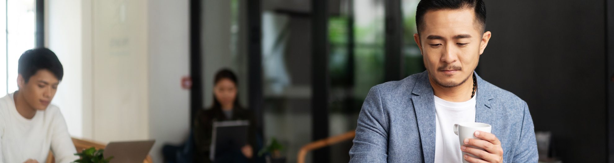 Young Businessman Working WIth Laptop Drinking Coffee