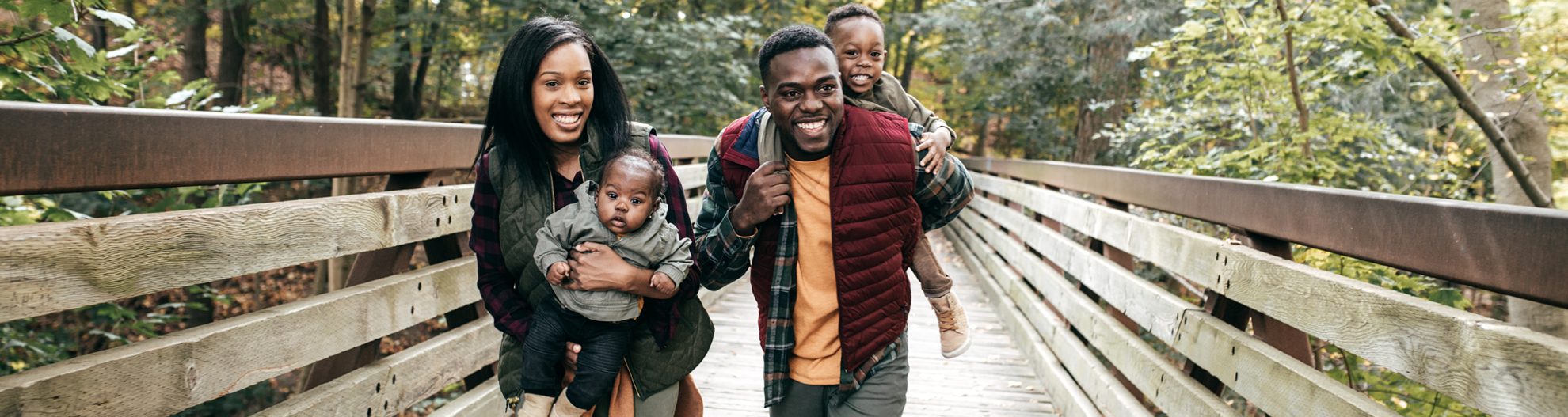 Parents with small children walking across bridge