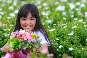 child flowers grass