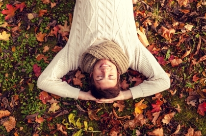 Man laying on back in fallen leaves