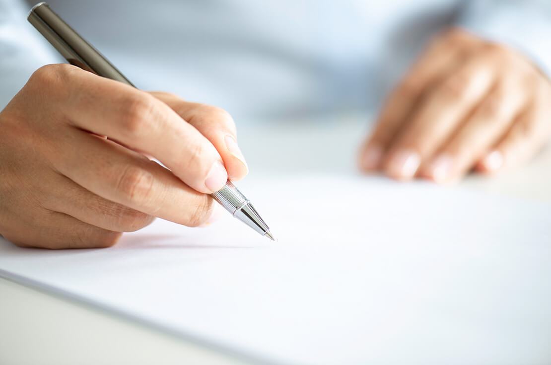 Close up of an unrecognizable businessman signing contract paper