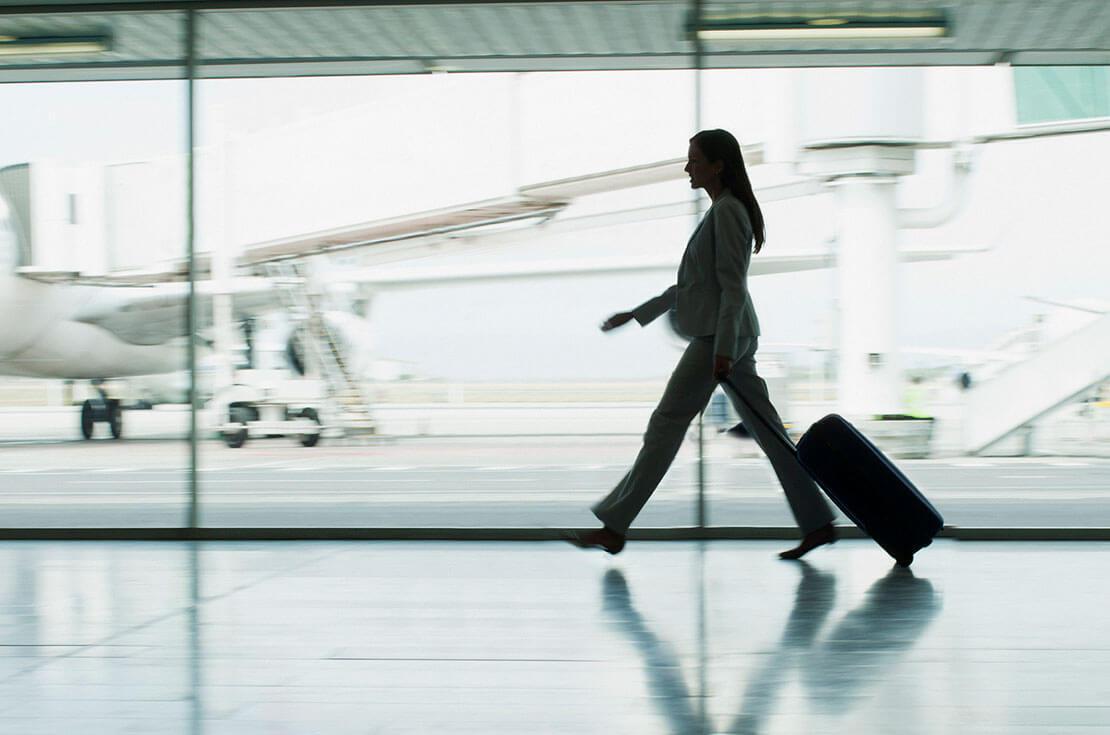 Businesswoman with suitcase in airport